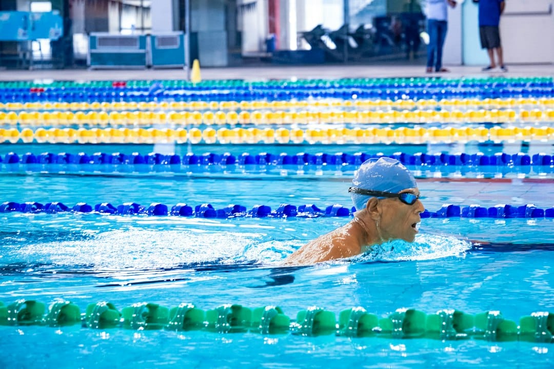 Competitive swimmer wearing swimming goggles during a pool race