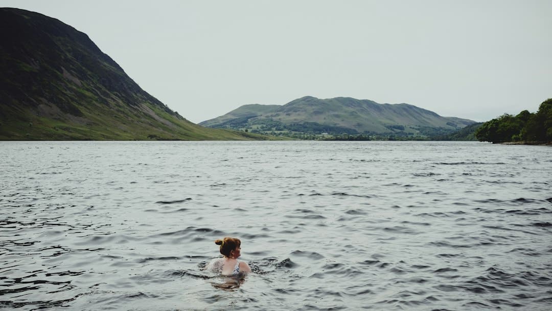 Open-water swimmer wearing goggles in a lake